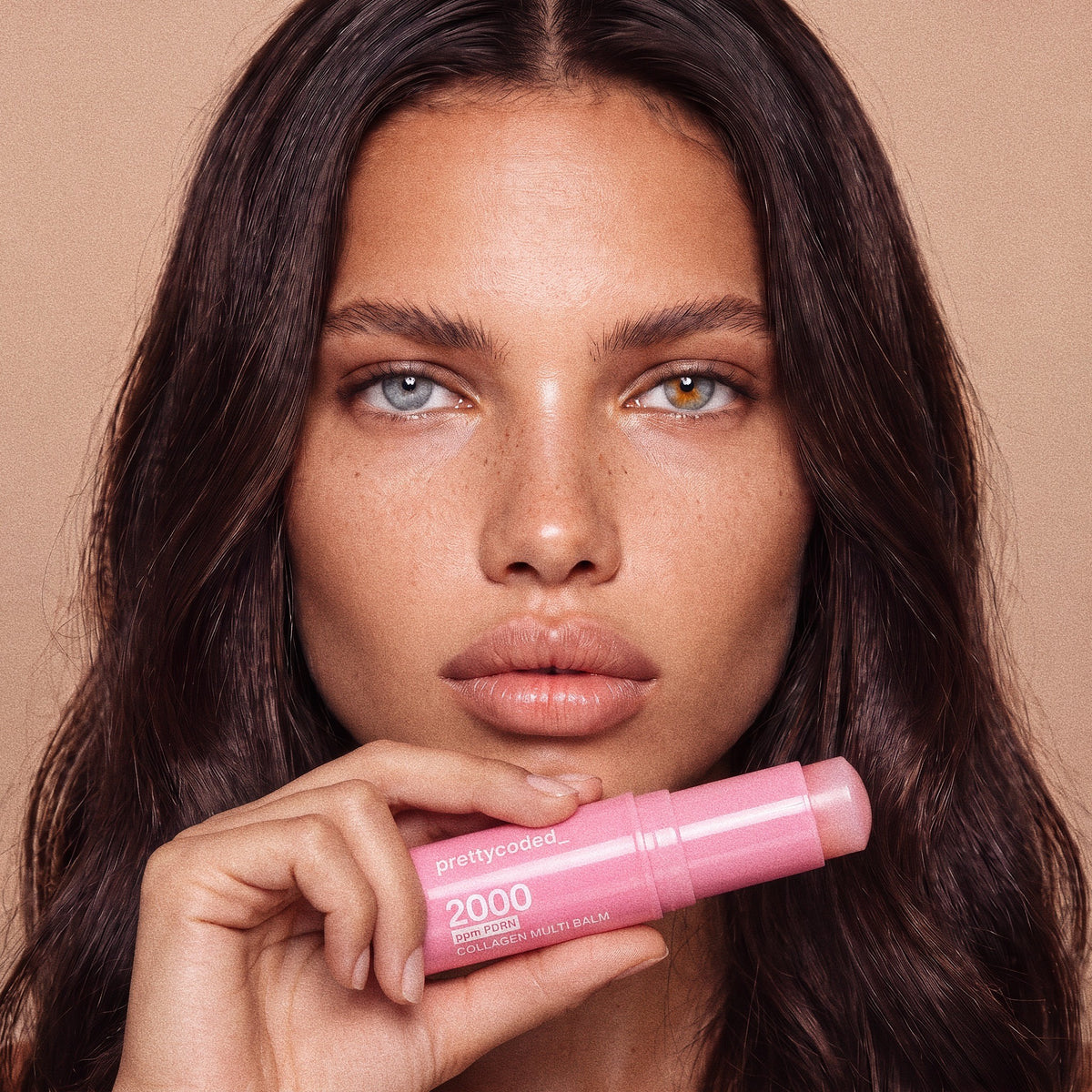 Model holding the prettycoded PDRN Collagen Multi Balm stick